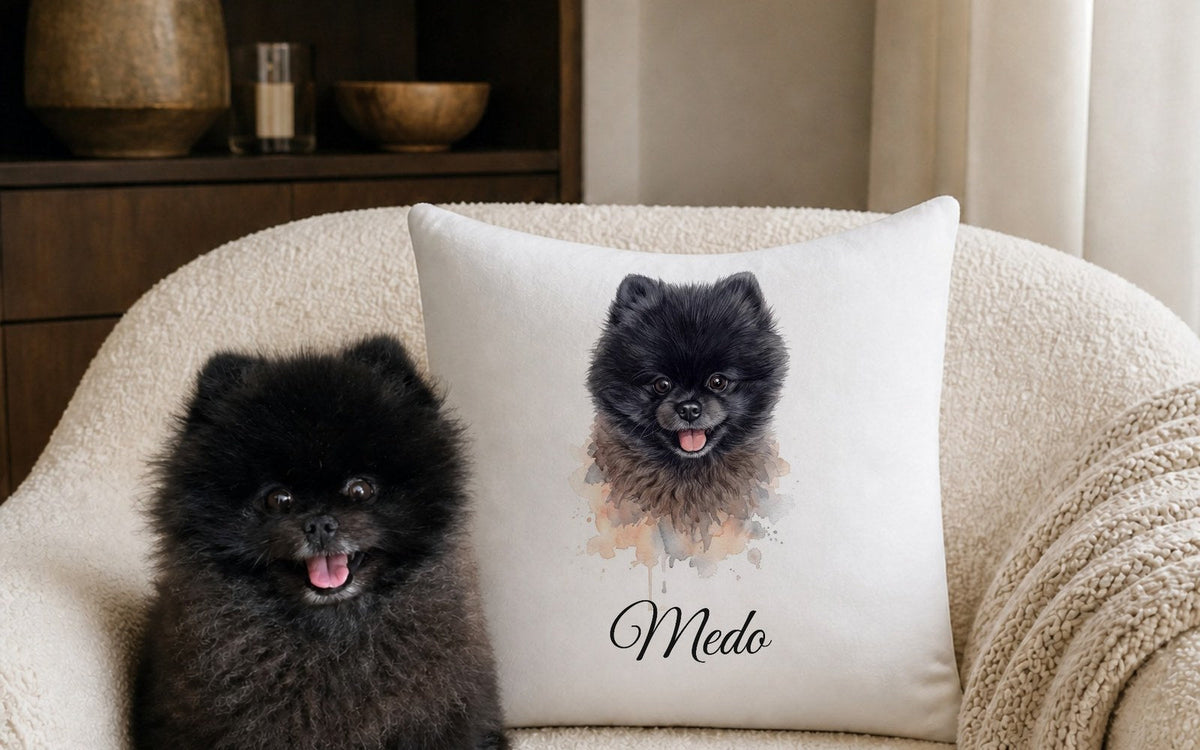 Cushion with a watercolour dog portrait on an armchair next to the dog